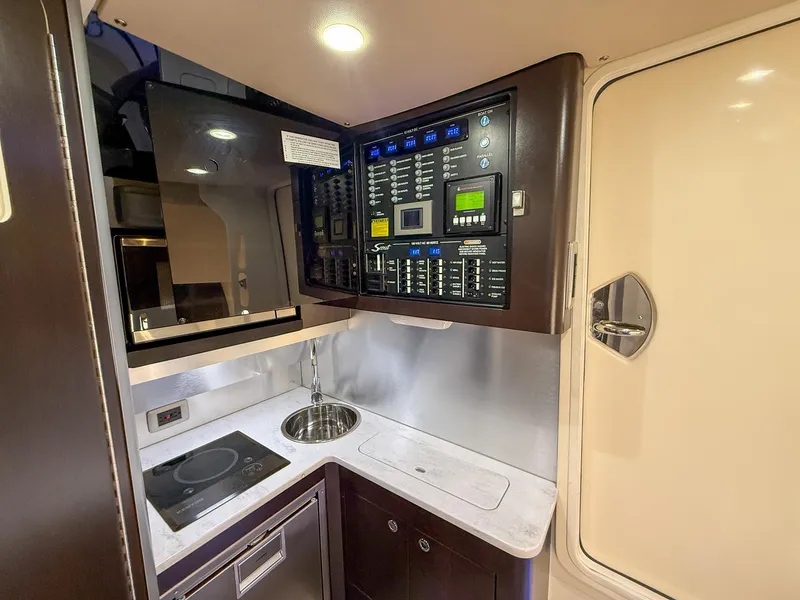Slide: The Image of 2020 Scout 380 LXF yacht interior with control panel, sink, and induction cooktop. - 28