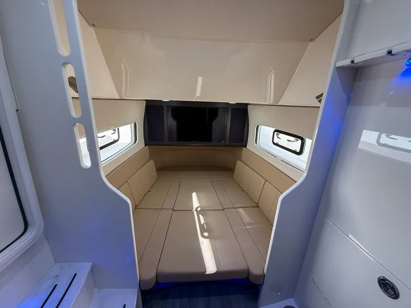Slide: The Image of Luxurious interior cabin of 2020 Scout 380 LXF boat with beige seating and windows. - 29