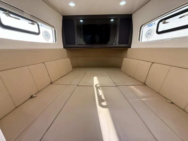 Slide: The Image of Luxurious interior cabin of 2020 Scout 380 LXF boat with beige seating and TV. - 30