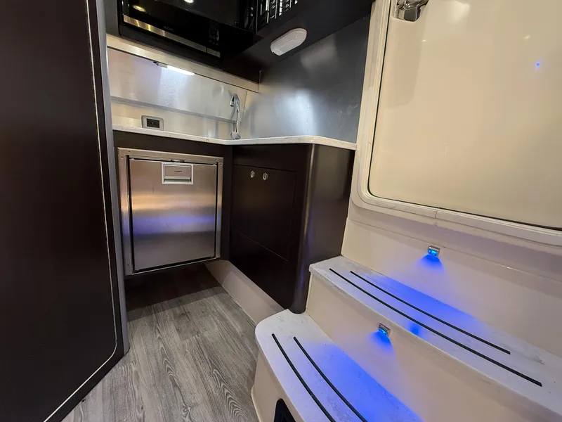Slide: The Image of Interior of 2020 Scout 380 LXF boat with modern kitchen and illuminated steps. - 38