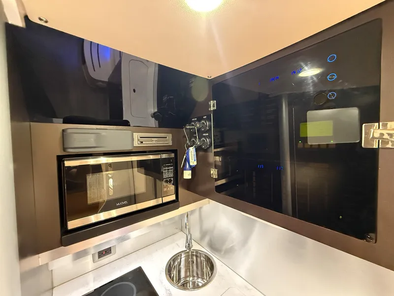 Slide: The Image of Modern kitchen area in 2020 Scout 380 LXF boat with microwave and sink. - 40