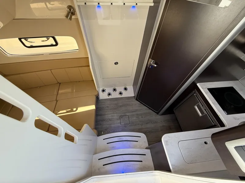 Slide: The Image of Interior of 2020 Scout 380 LXF boat with seating, kitchenette, and modern design. - 45