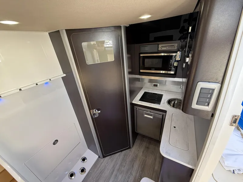 Slide: The Image of 2020 Scout 380 LXF cabin interior with kitchenette, featuring microwave, sink, and modern design. - 46