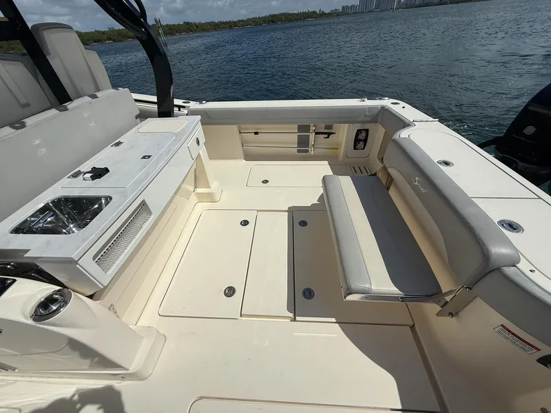 Slide: The Image of 2020 Scout 380 LXF boat interior with seating and sink, overlooking water. - 48