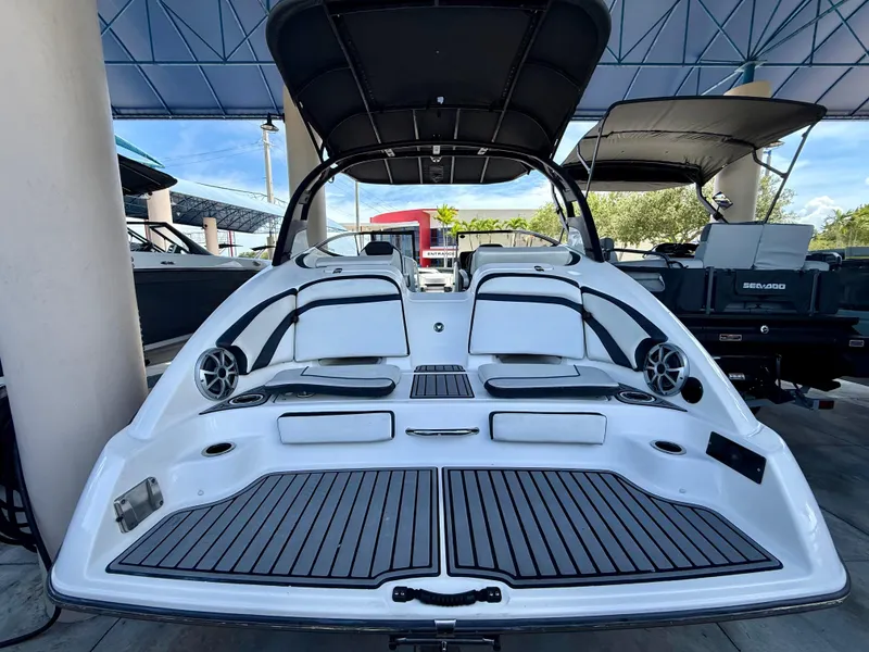 Slide: The Image of 2018 Yamaha Boats 242 Limited S E-Series, rear view, showcasing spacious deck and seating. - 3