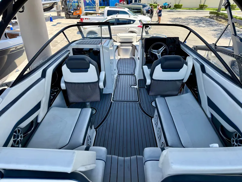 Slide: The Image of 2018 Yamaha Boats 242 Limited S E-Series interior with sleek seating and modern dashboard. - 5