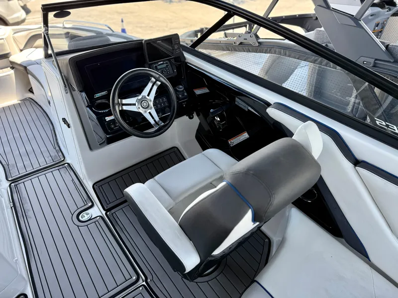 Slide: The Image of 2018 Yamaha Boats 242 Limited S E-Series cockpit with steering wheel and dashboard controls. - 7
