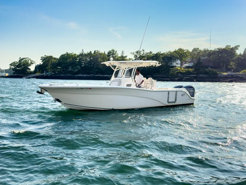 The Image of 2022 Sea Fox 288 Commander boat cruising on a sunny day near a wooded shoreline. - 0