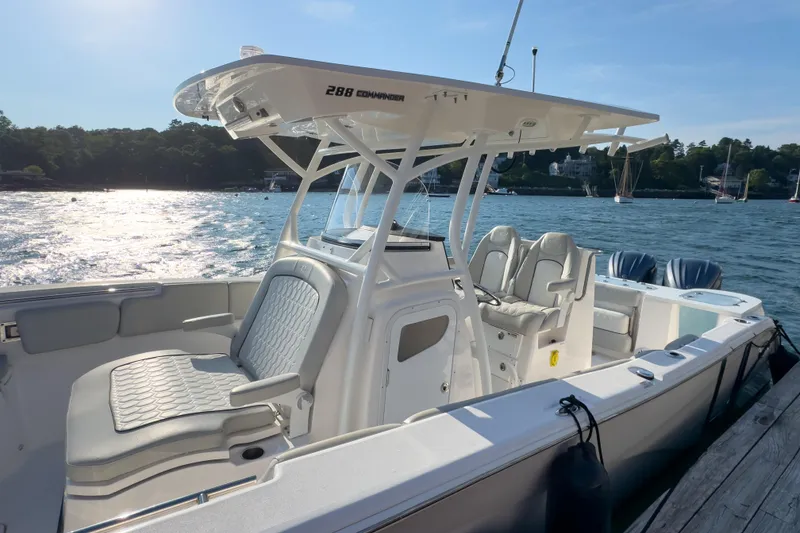 Slide: The Image of 2022 Sea Fox 288 Commander boat docked by the water, featuring comfortable seating and sleek design. - 11