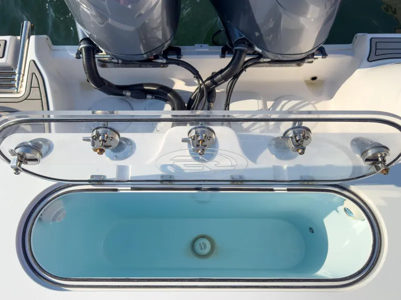 Slide: The Image of 2022 Sea Fox 288 Commander boat with open livewell and dual outboard motors. - 18