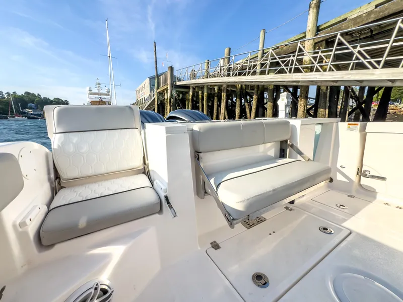 Slide: The Image of 2022 Sea Fox 288 Commander boat interior with comfortable seating near a dock. - 20