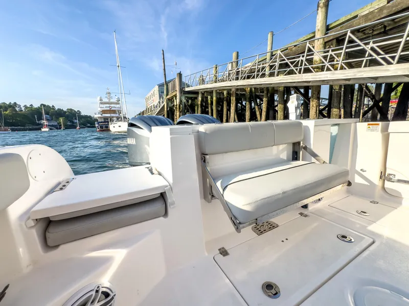 Slide: The Image of 2022 Sea Fox 288 Commander boat interior with seating, docked near a wooden pier. - 21