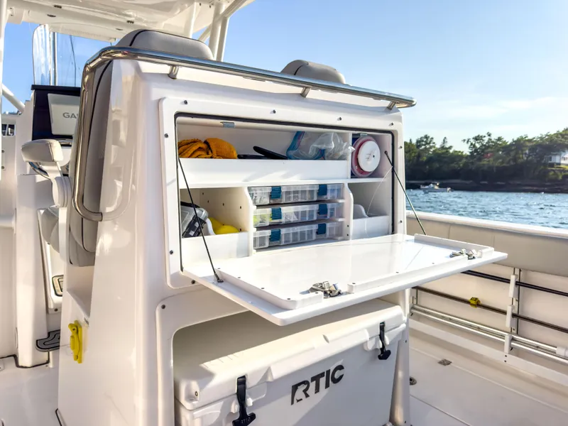 Slide: The Image of 2022 Sea Fox 288 Commander boat with open storage compartment and RTIC cooler. - 25