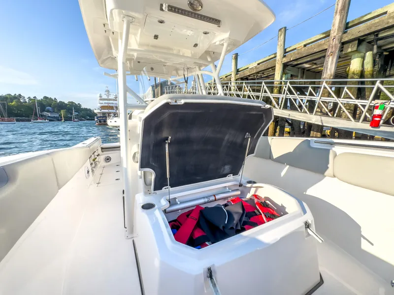 Slide: The Image of 2022 Sea Fox 288 Commander boat with open storage compartment, dockside view. - 36