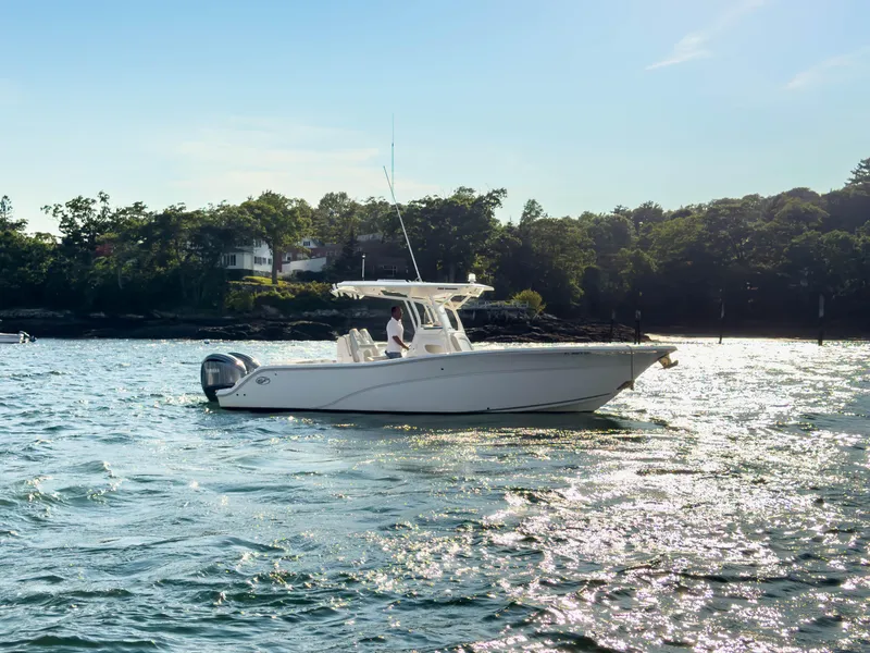 Slide: The Image of 2022 Sea Fox 288 Commander boat on water, with scenic shoreline background. - 5