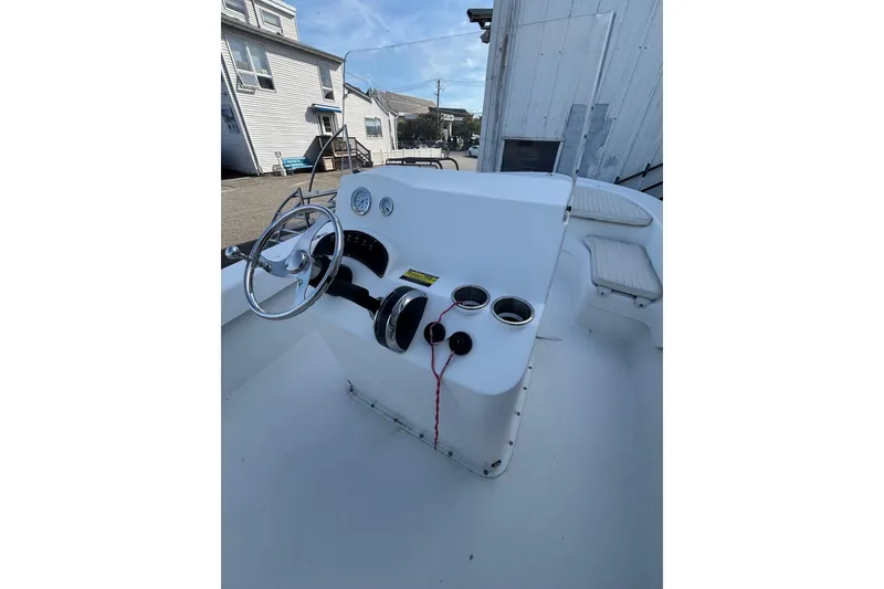 Slide: The Image of 2021 Savannah SS19 boat interior with steering wheel and control panel. - 16