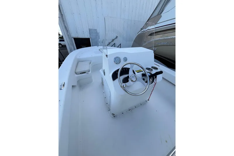 Slide: The Image of 2021 Savannah SS19 boat helm with steering wheel and controls. - 17