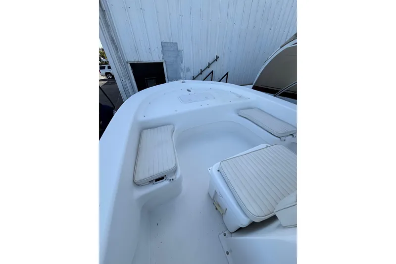 Slide: The Image of 2021 Savannah SS19 boat interior with white cushioned seating. - 19
