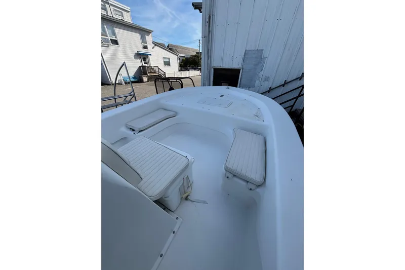 Slide: The Image of 2021 Savannah SS19 boat interior with white seating, docked near buildings. - 20