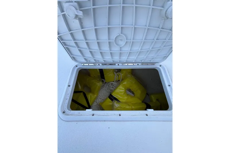 Slide: The Image of Open hatch on Savannah SS19 boat, revealing yellow life jackets inside. - 21