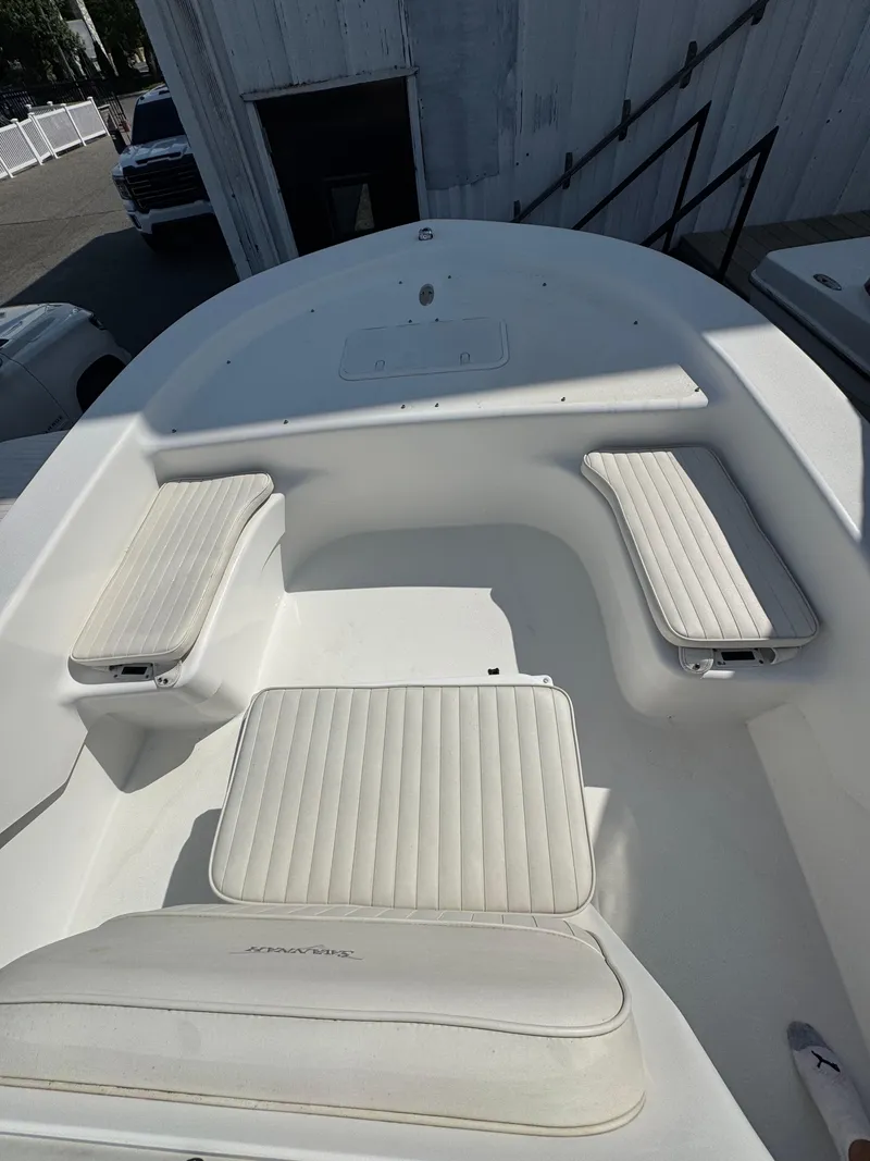 Slide: The Image of 2021 Savannah SS19 boat with Mercury outboard motor, parked outdoors. - 3