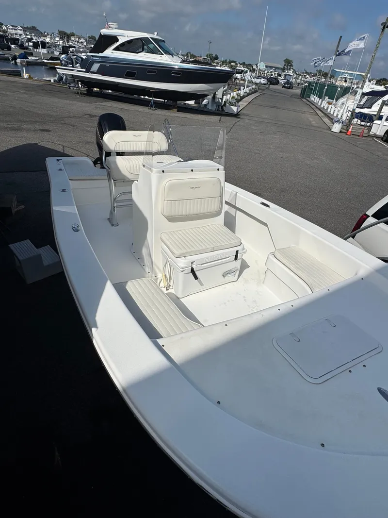 Slide: The Image of 2021 Savannah SS19 boat with outboard motor, parked on concrete surface. - 4