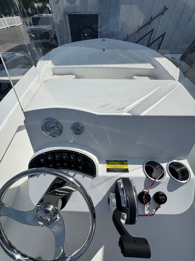 Slide: The Image of 2021 Savannah SS19 boat, white deck, docked, with seating and storage compartments. - 5