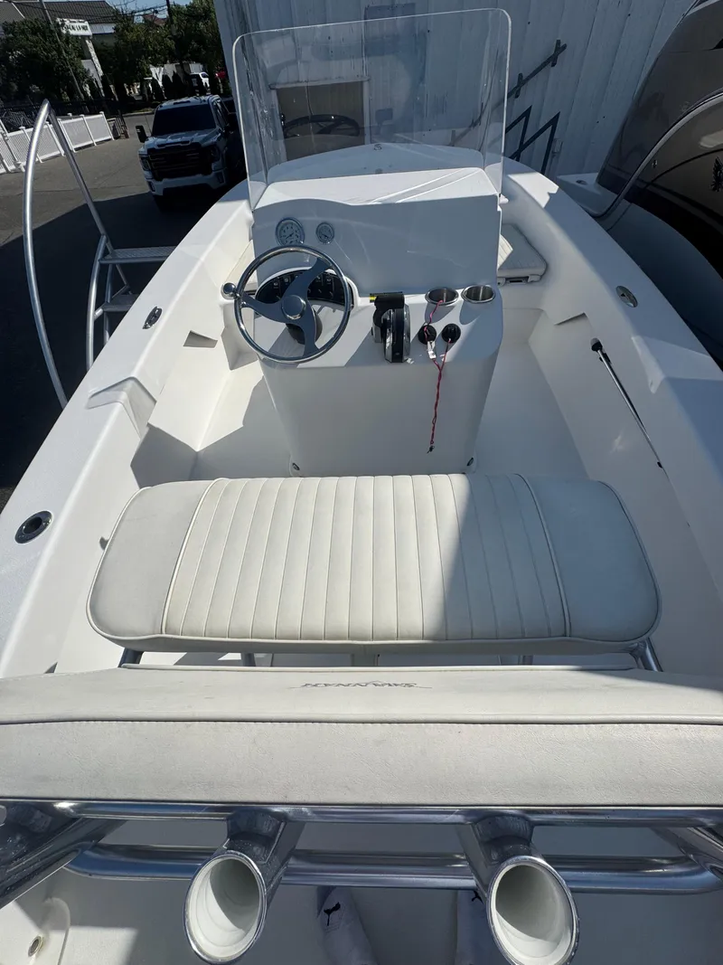 Slide: The Image of 2021 Savannah SS19 boat with white seating, docked at a marina. - 6