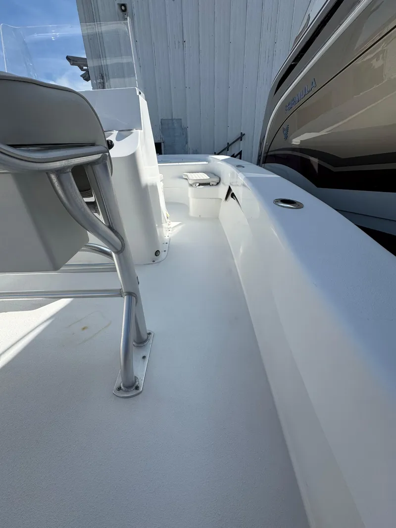 Slide: The Image of 2021 Savannah SS19 boat docked at marina, featuring sleek white design and seating. - 8
