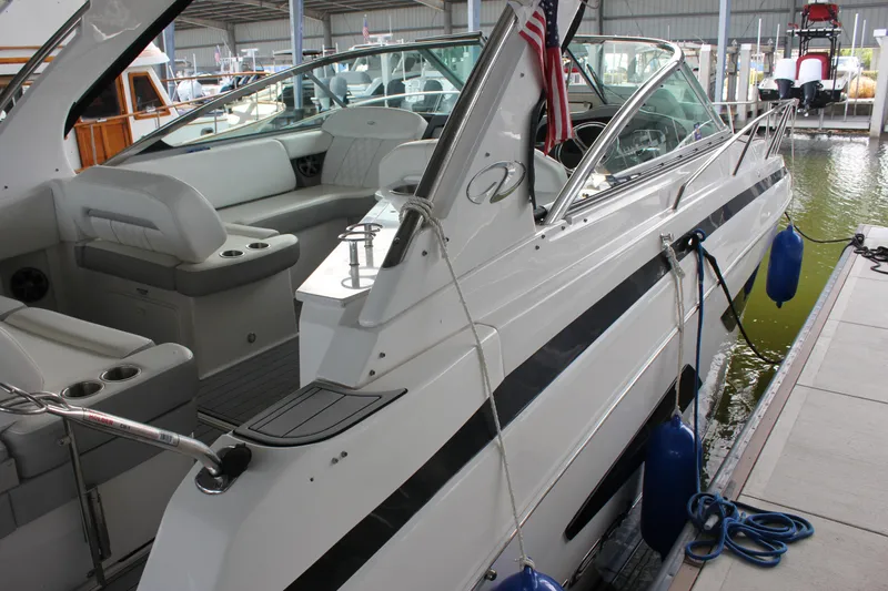 Slide: The Image of 2021 Regal 33 XO boat docked, featuring sleek design and spacious seating area. - 11