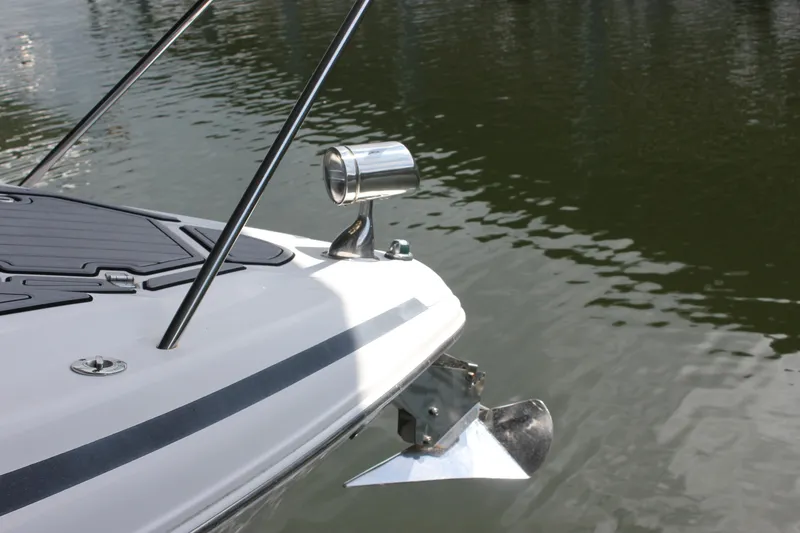 Slide: The Image of 2021 Regal 33 XO boat bow with anchor and spotlight on water. - 15