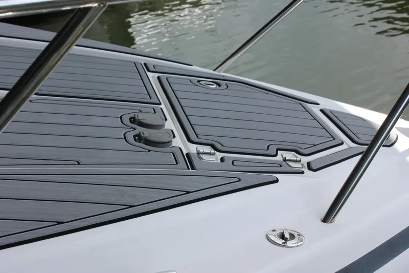 Slide: The Image of 2021 Regal 33 XO boat deck with sleek, modern design and water in the background. - 16