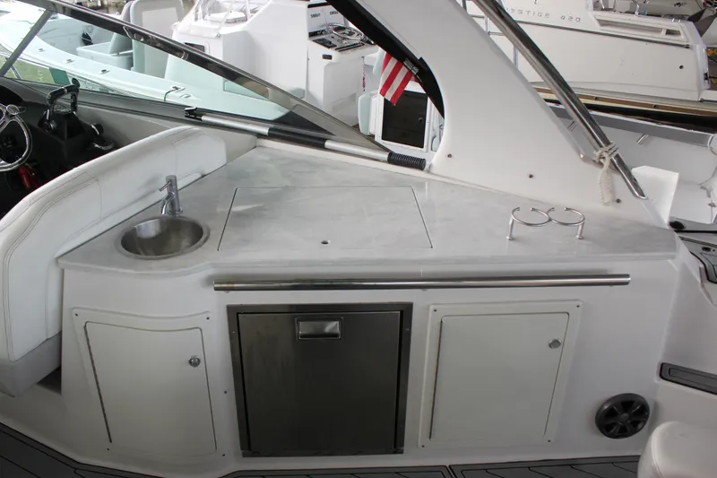 Slide: The Image of 2021 Regal 33 XO boat interior with sink, countertop, and storage cabinets. - 20