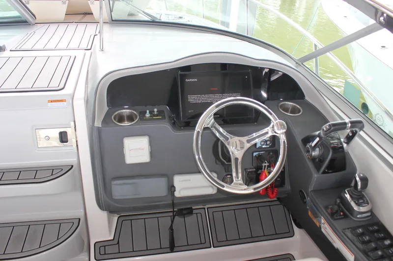Slide: The Image of 2021 Regal 33 XO boat helm with steering wheel and control panel. - 21