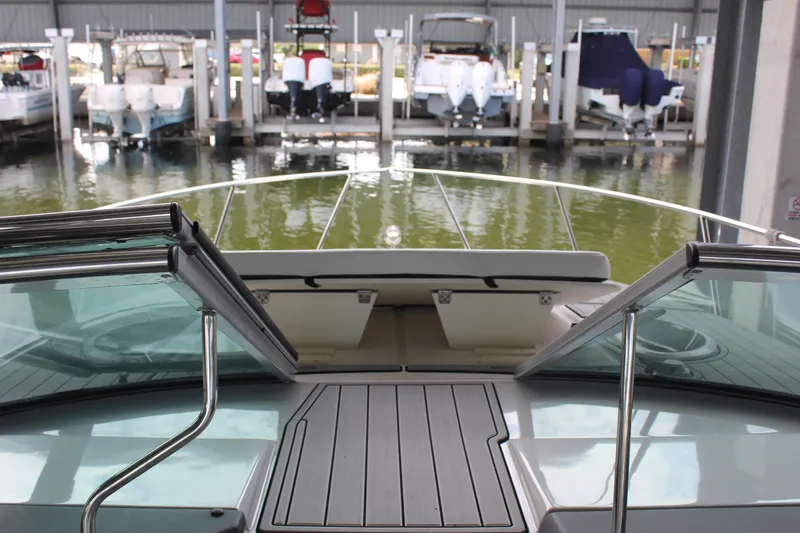 Slide: The Image of 2021 Regal 33 XO boat docked, view from deck with open windshield. - 24
