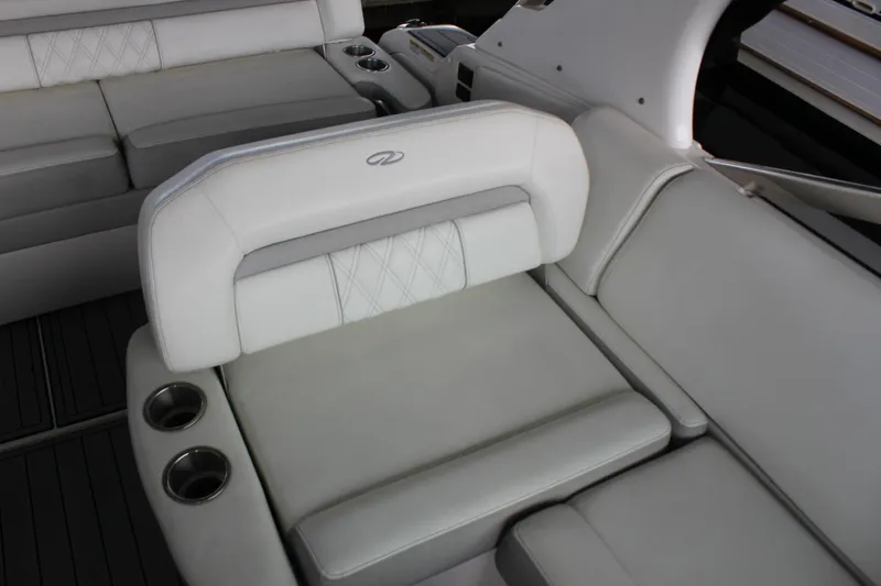 Slide: The Image of Luxurious seating on 2021 Regal 33 XO boat with cup holders and elegant design. - 26