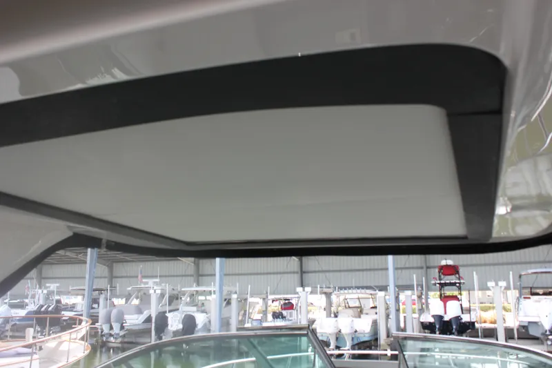 Slide: The Image of 2021 Regal 33 XO boat interior roof view in a marina setting. - 35