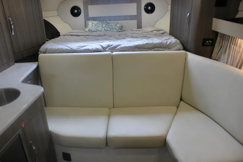 Slide: The Image of Interior of 2021 Regal 33 XO boat with bed, sofa, and kitchenette. - 37