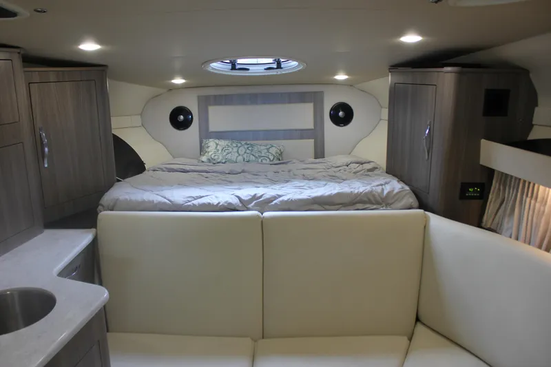 Slide: The Image of Interior of 2021 Regal 33 XO yacht with cozy bed and modern cabinetry. - 38