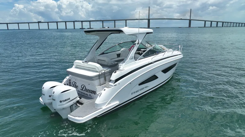 Slide: The Image of 2021 Regal 33 XO luxury boat with sleek design in marina setting. - 4