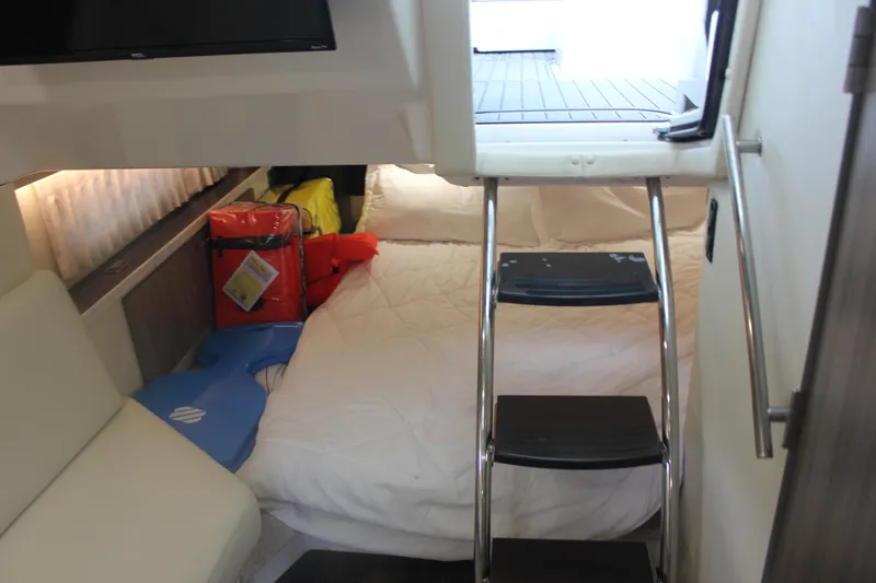Slide: The Image of Interior cabin of 2021 Regal 33 XO boat with bed and ladder access. - 41