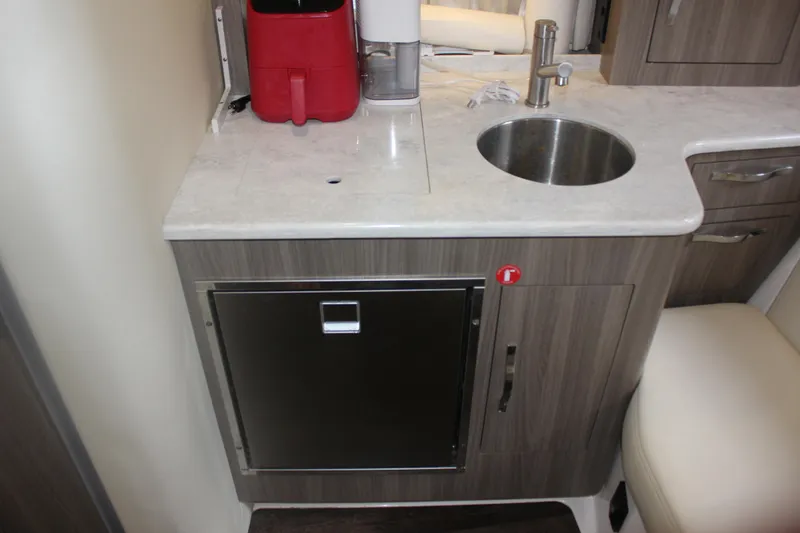 Slide: The Image of 2021 Regal 33 XO boat interior kitchenette with sink and countertop. - 44