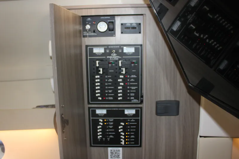 Slide: The Image of Electrical panel inside 2021 Regal 33 XO boat, featuring switches and gauges. - 46