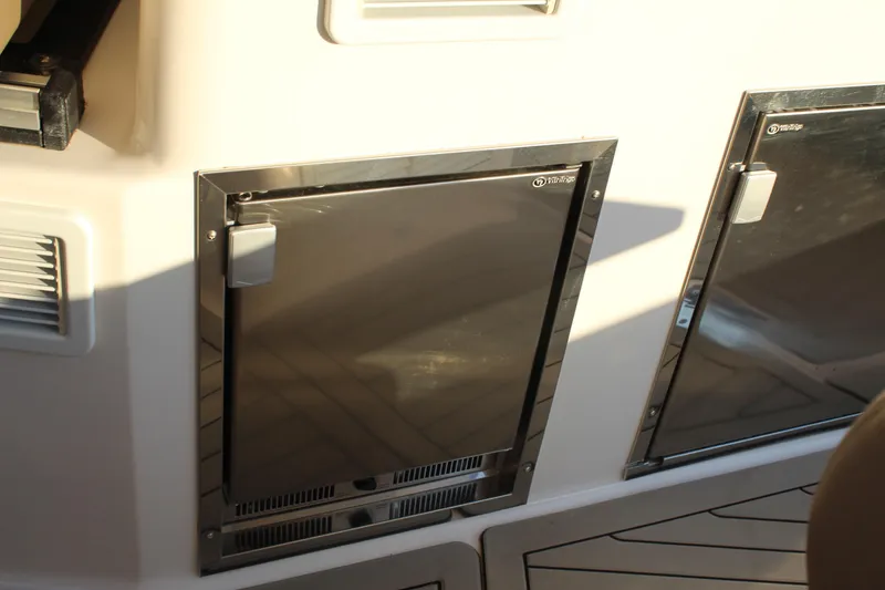 Slide: The Image of Stainless steel fridge doors on 2015 Regal 35 Sport Coupe boat interior. - 33