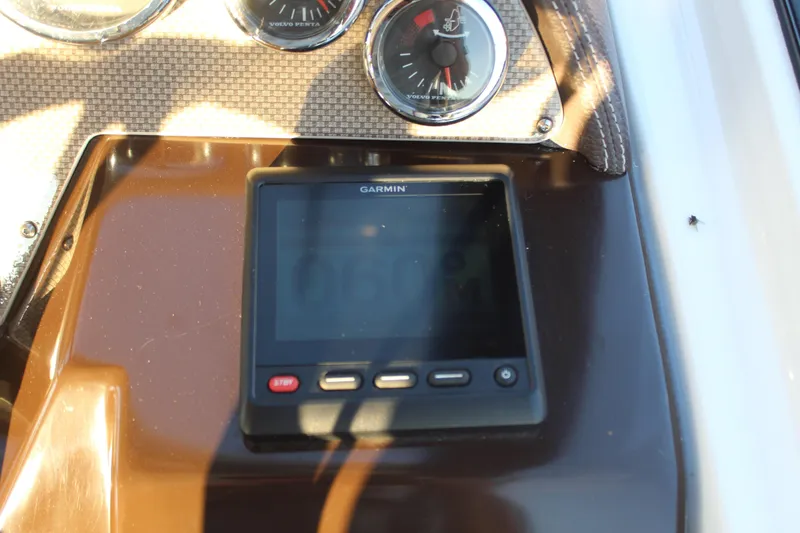 Slide: The Image of Garmin display and gauges on 2015 Regal 35 Sport Coupe dashboard. - 43