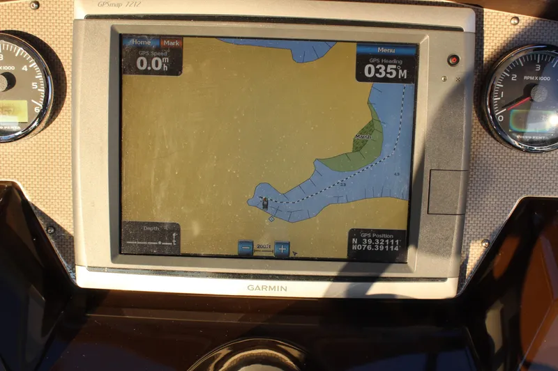 Slide: The Image of Garmin GPS display on 2015 Regal 35 Sport Coupe dashboard, showing navigation map and gauges. - 44