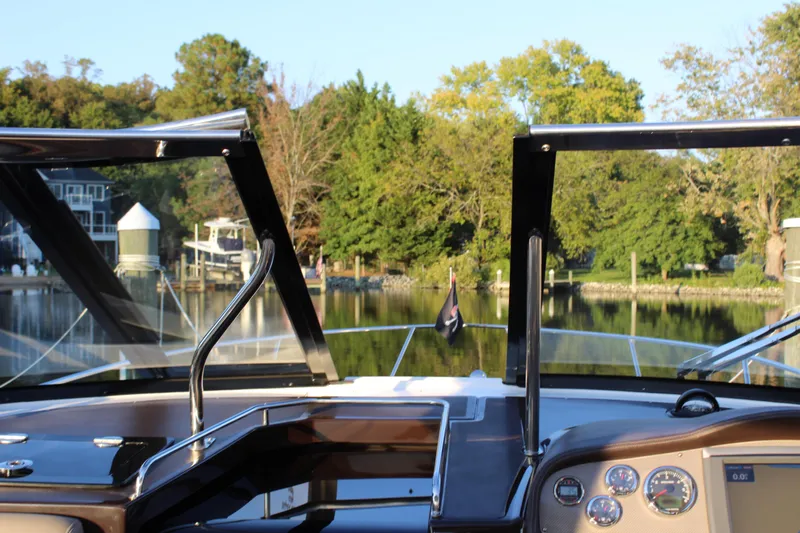 Slide: The Image of 2015 Regal 35 Sport Coupe dashboard view with scenic waterfront background. - 50
