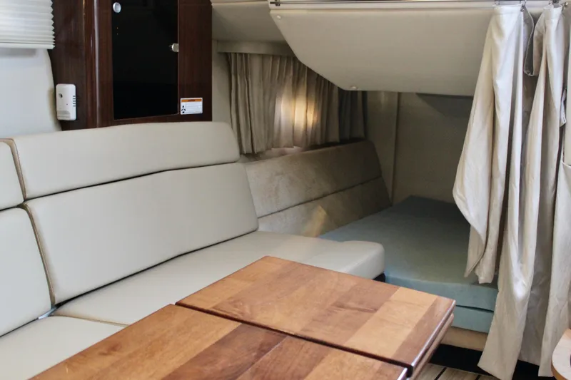Slide: The Image of Interior of 2015 Regal 35 Sport Coupe with seating and wooden table. - 55