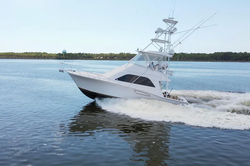 Slide: The Image of 2005 Cabo 40 Flybridge yacht cruising on calm waters. - 100