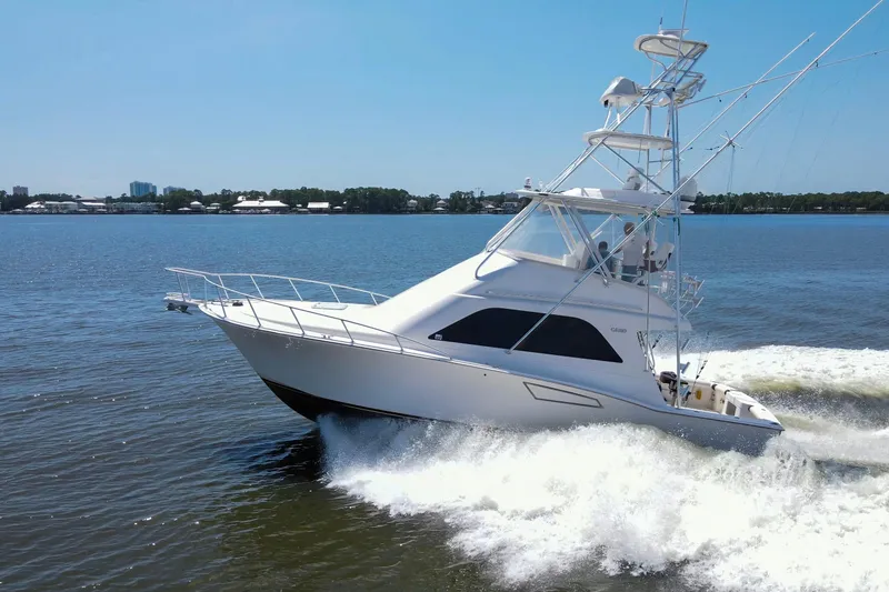 Slide: The Image of 2005 Cabo 40 Flybridge yacht cruising on open water under clear blue sky. - 104
